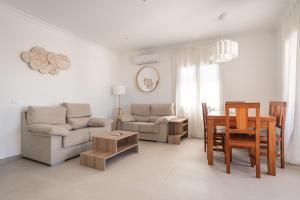 a living room with a couch and a table at V110B Villa La Pau in Son Bou