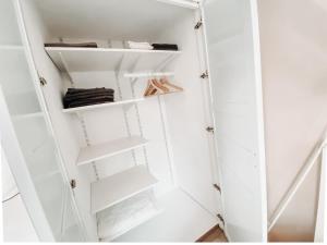a white closet with white shelves at Casa Bonita in Heikendorf