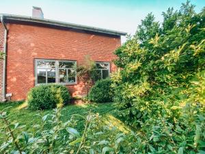 a brick building with a window and a yard at Casa Bonita in Heikendorf