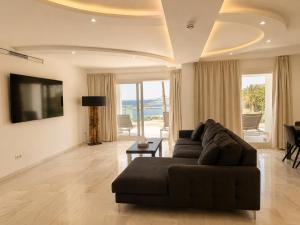 a living room with a couch and a television at B51 Executive Flats Marbella in Marbella