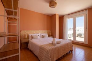 a bedroom with a bed and a large window at The Loft House Ibiza in Santa Eularia des Riu +66 photos
