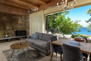 a living room with a couch and a table at Amicasa Private Seaside Suite in Pachis