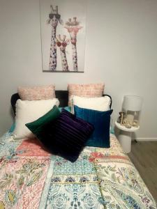 a bedroom with a bed with a quilt and pillows at Olivers Home in Forbes