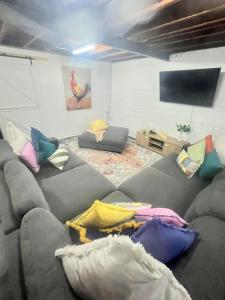a living room with a couch with pillows on it at Olivers Home in Forbes