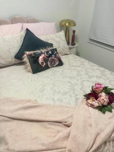 a bed with two pillows with flowers on it at Olivers Home in Forbes +5 photos