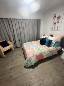 a bedroom with a bed and a chair in it at Olivers Home in Forbes