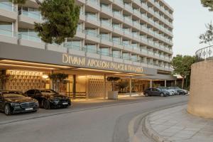 a building with cars parked in front of it at Divani Apollon Palace & Thalasso in Athens