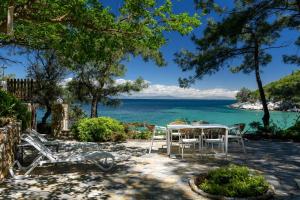 a table and chairs with a view of the ocean at Amicasa Private Seaside Suite in Pachis +22 photos