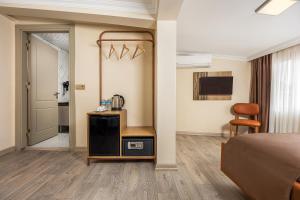 a bedroom with a bed and a table and a mirror at Taksim Peradise Hotel in Istanbul