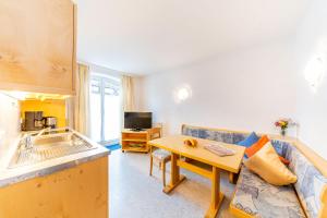 a living room with a couch and a table at Hotel Alpenhof in Bad Wörishofen