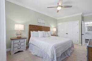 a bedroom with a bed and a ceiling fan at Periwinkle Paradise in Navarre +75 photos
