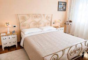 a bedroom with a large bed and two night stands at Villa Bruna in Cesenatico