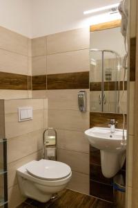 a bathroom with a toilet and a sink at Kolegium Nowe PANS - hostel in Przemyśl +35 photos