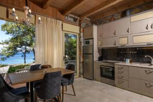 a kitchen with a table and chairs and a dining room at Amicasa Private Seaside Suite in Pachis