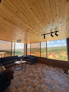 a living room with a couch and a table at Green forest farm in Ajloun +28 photos