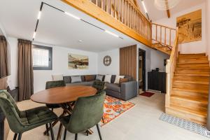 a living room with a table and a couch at Muraga Villas by PikHost in Tirana