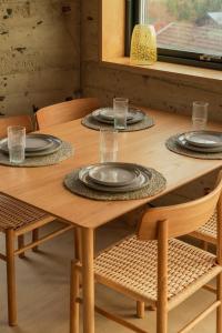a wooden table with four plates on it at Á Varða Apartments in Tórshavn +10 photos