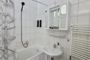 a white bathroom with a sink and a shower at Privileg - NewTime in Viersen