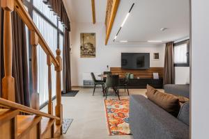 a living room with a couch and a table at Muraga Villas by PikHost in Tirana