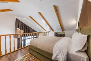 a bedroom with a bed and a balcony at Muraga Villas by PikHost in Tirana