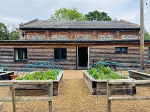 two raised beds in front of a building at The Goods Shed in Narborough