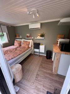 a bedroom with a bed and a desk in a van at Murrebo citystay in Örebro