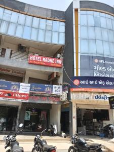 a group of motorcycles parked in front of a building at Hotel Radhe Inn in Gandhinagar