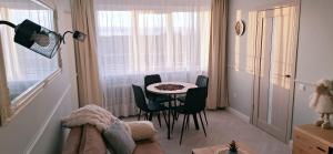 a small dining room with a table and chairs at Fountain View 2 bedroom Apartment in Naujoji Akmenė