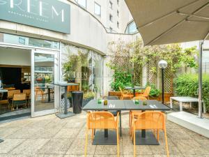 a patio with a table and chairs in front of a building at Novotel Paris Charenton le Pont in Charenton-le-Pont