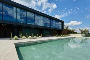 a building with a swimming pool in front of a building at Hotel Aquafalls in Caniçada
