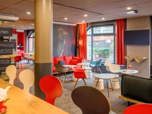 a restaurant with colorful chairs and tables in a room at ibis Toulouse Centre in Toulouse