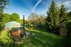 a backyard with a hot tub and a gazebo at Jurta pod Blaníkem s wellnes in Chotýšany