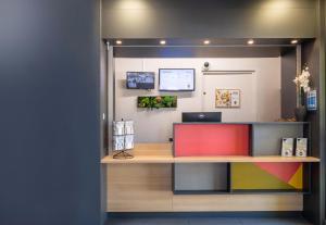 an office with a desk with a laptop on it at B&B HOTEL Annecy Argonay in Argonay