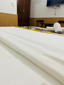 a bed with white sheets and towels on it at Minh Thư Phú Mỹ Hotel in Phú Mỹ +25 photos