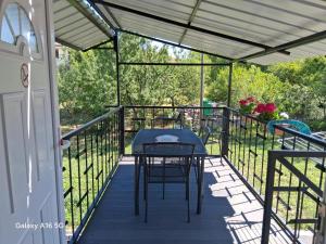 a patio with a table and chairs on a deck at Appartement Nicole BENKOVAC in Benkovac +5 photos