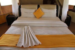 a large bed with two pillows on top of it at Nature Haven Mara Camp in Ololaimutiek