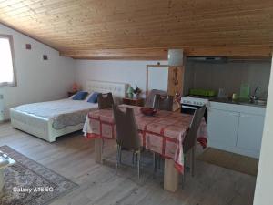 a bedroom with a bed and a table and a kitchen at Appartement Nicole BENKOVAC in Benkovac