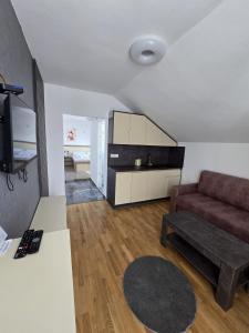 a living room with a couch and a table at Vila La Familia in Budžak