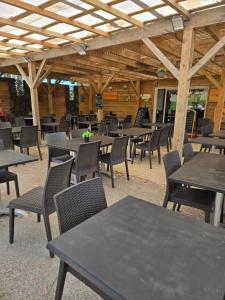 a group of tables and chairs in a restaurant at Iscles 231- MH Au calme près du lac in La Roque-dʼAnthéron