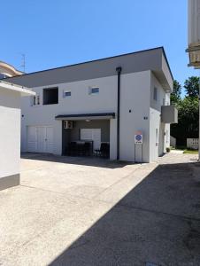 a large white building with a large garage at Apartment GORA in Međugorje
