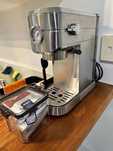 a coffee maker sitting on a counter next to a mixer at warm, quiet and convenient ! in Auckland