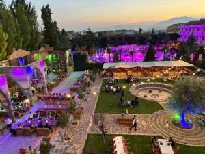 an aerial view of an outdoor event with purple lighting at فندق الخيال الكبير in Zahlé