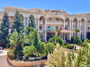 a large building with trees in front of it at فندق الخيال الكبير in Zahlé