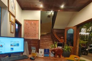 a computer on a desk in a room with a staircase at Archaic House- Siem Reap in Siem Reap
