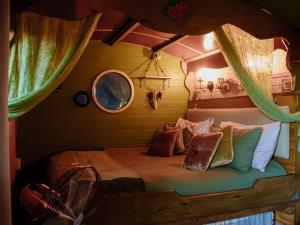 a bedroom with a bed in a tree house at Gypsy Vans Weskus in Jacobs Bay +73 photos