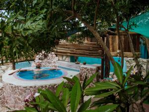 a man in a swimming pool in a resort at Gypsy Vans Weskus in Jacobs Bay