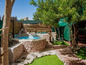 a backyard with a swimming pool and a tree at Gypsy Vans Weskus in Jacobs Bay