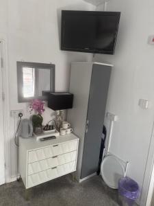 a room with a white dresser with a tv on the wall at The Cosy Nook in Blackpool +80 photos