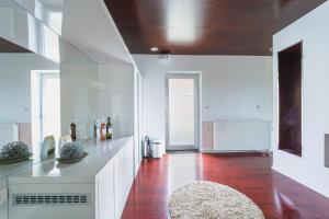 a kitchen with white cabinets and a red floor at Ladanjsko Imanje Principovac in Ilok