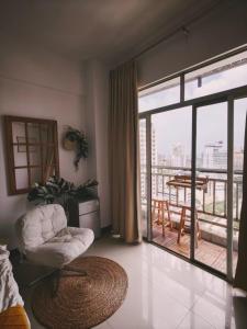 a living room with a large glass door to a balcony at Ek民宿 in Beihai
